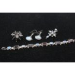 A silver garnet and moonstone bracelet, a ring, cross pendant and pair of ear rings, 46gm
