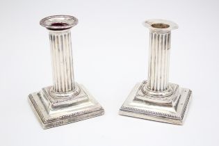 A Victorian silver pair of desk candlesticks, Sheffield 1898, 12cm, loaded, lacking one scone.