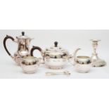 A four piece electroplated tea service, a pair of sugar tongs and a candlestick