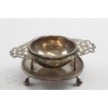 A silver tea strainer on stand, Sheffield 1917, 10.5cm across handles, 79gm