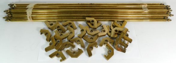 A set of fourteen Edwardian solid brass stair rods with fittings.