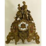 A gilt brass Ormolu style mantel clock, the scrolling floral case with inset marble panels housing a