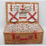 A modern wicker picnic basket with fitted interior.