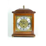 A modern mahogany bracket clock, the chased brass dial with silvered chapter ring, housing a Franz