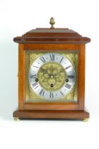 A modern mahogany bracket clock, the chased brass dial with silvered chapter ring, housing a Franz