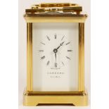 An English brass 8 day carriage clock, retailed by Garrard Of London, with key and presentation box.