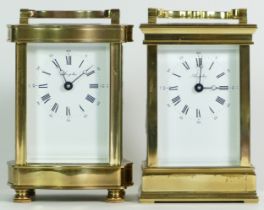 Two French brass 8 day carriage clocks, having enamelled dials with Roman numerals. (2)