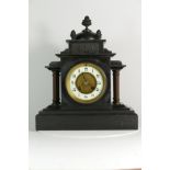 A Victorian slate mantel clock, the 8 day movement striking on gong. 33cm tall.