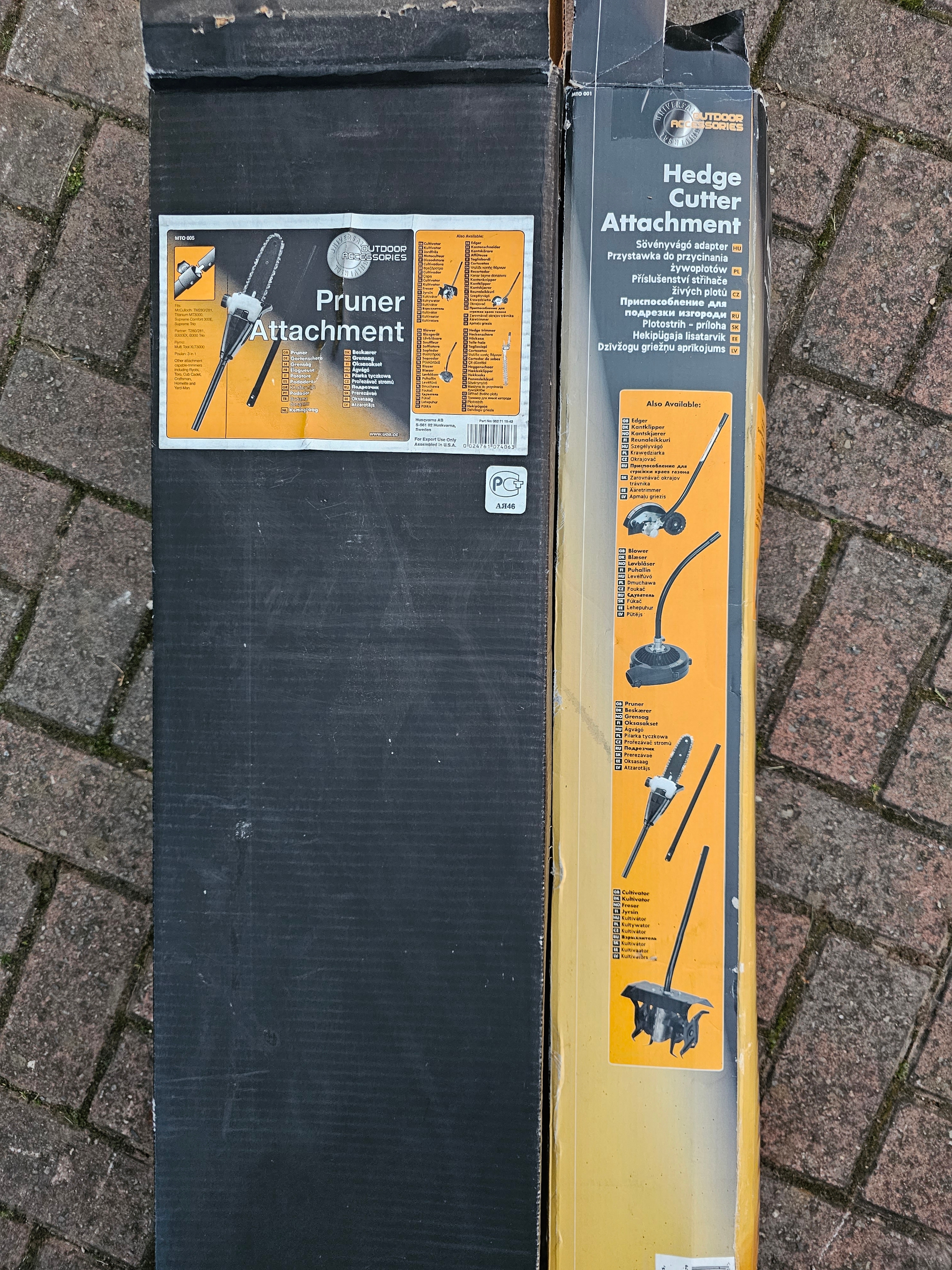 An Outdoor Accessories pruner attachment and a hedge cutter attachment, both unused