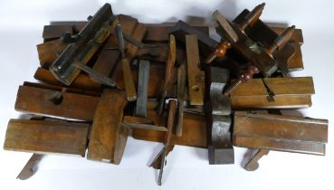 A collection of early 20th century carpenters tools, to include molding planes, chizels, and box