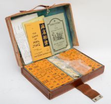 A late 20th century Mah Jong set, with bone counters, dice and composite bricks, with instrucions