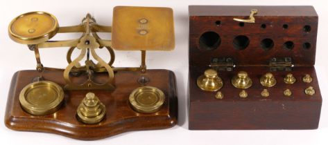 A set of early 20th century postal scales, together with a boxed set of additional postal