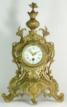 A 20th century French gilt brass Rococo style mantel clock, with an eight day movement. 50cm tall.