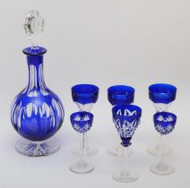 A 20th century Bohemian blue glass decanter, together with a set of four matching sherry glasses and