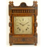 An Edwardian oak bracket clock, the case with open fretwork gallery, turned columns and finials with