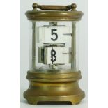 An early 20th century brass ticket clock. 13.5cm tall.