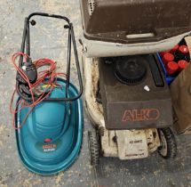 An Alko 42BWE self propelled petrol lawnmower with basket and instructions and a Bosh hover mower