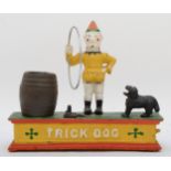 A cast iron automated money bank 'Trick Dog' 19cm tall.