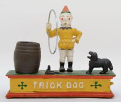 A cast iron automated money bank 'Trick Dog' 19cm tall.