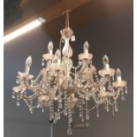 A glass and perspex lustre drop eight branch two tier chandelier, 80cm drop