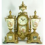 A Regency style gilt brass Ormolu mantel clock and garniture, the eight day movement striking on