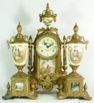 A Regency style gilt brass Ormolu mantel clock and garniture, the eight day movement striking on