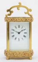 A mid 20th century brass carriage clock, having enamelled dial with Roman numerals, with platform