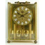 A mid 20th century West German 'Korma' mantel clock, brass case with glass panels, housing an