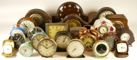 A collection of mechanical clocks, including alarm, desk and mantle clocks, from brands such as
