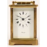 A French brass carriage clock, having a jewelled 8 day movement, boxed with key. 12cm tall.