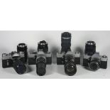 Four 35mm film cameras with lenses, to include a Zenit-E with a Pentacon 80mm-200mm f4.5-f5.6