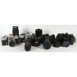 Four 35mm film cameras with lenses, to include a Praktica MTL with a Carl Zeiss Jena 50mm f2.8 lens,