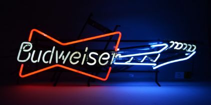 A neon sign advertising Budweiser, in the form of an electric guitar, 95 x 34 x 18cm
