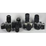 Four 35mm film cameras with lenses, to include a Canon EOS 300 with a 70mm-210mm f4-f5.6 lens, a