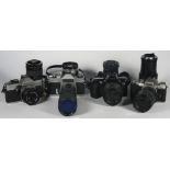 Four 35mm film cameras with lenses, to include a Canon EOS 500 with a Sigma 70mm-210mm f4-f5.6 lens,