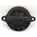 A round cast-iron wagon plate 'L.M.S 1939, standard 14 tons, No 168019'.