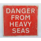 A painted aluminium sign 'Danger From Heavy Seas' 67x60cm.