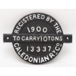 A round cast iron wagon plate 'Caledonian RY.Co. 1900, to carry 10 tons, No 13337'.