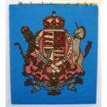 The Royal Coat Of Arms Of The United Kingdom, hand stitched fabric on a blue background, hanging