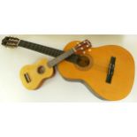 An Artisan acoustic guitar, together with a Sunwolf child's guitar with case. (2)