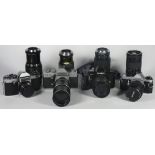 Four 35mm film cameras with lenses, to include a Praktica LTL3 with a 200mm f3.5 lens, a Praktica