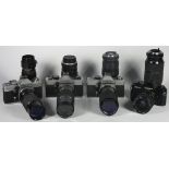 Four 35mm film cameras with lenses, to include a Praktica LTL with a Sirius 80mm-200mm f3.9 lens,