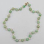 A Jadeite and faceted glass bead hand knotted necklace, 1cm beads, 44cm, 52gm.
