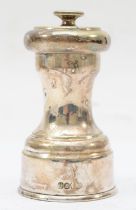 A silver plated mechanical pepper pot,9 x 4.5cm.