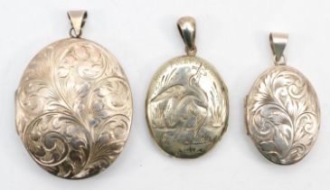 Two silver lockets with chase floral and scrolling detail, largest 5.5cm, 33gm, together with a