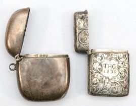 A Victorian silver vesta case, Birmingham 1889, with chased scroll decoration, together with