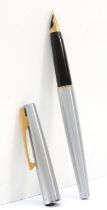 Sheaffer, a steel bodied fountin pen with 14k gold nib, 14cm.