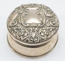 An Elizabeth II silver trinket box with lined interior and embossed decoration to the lid,