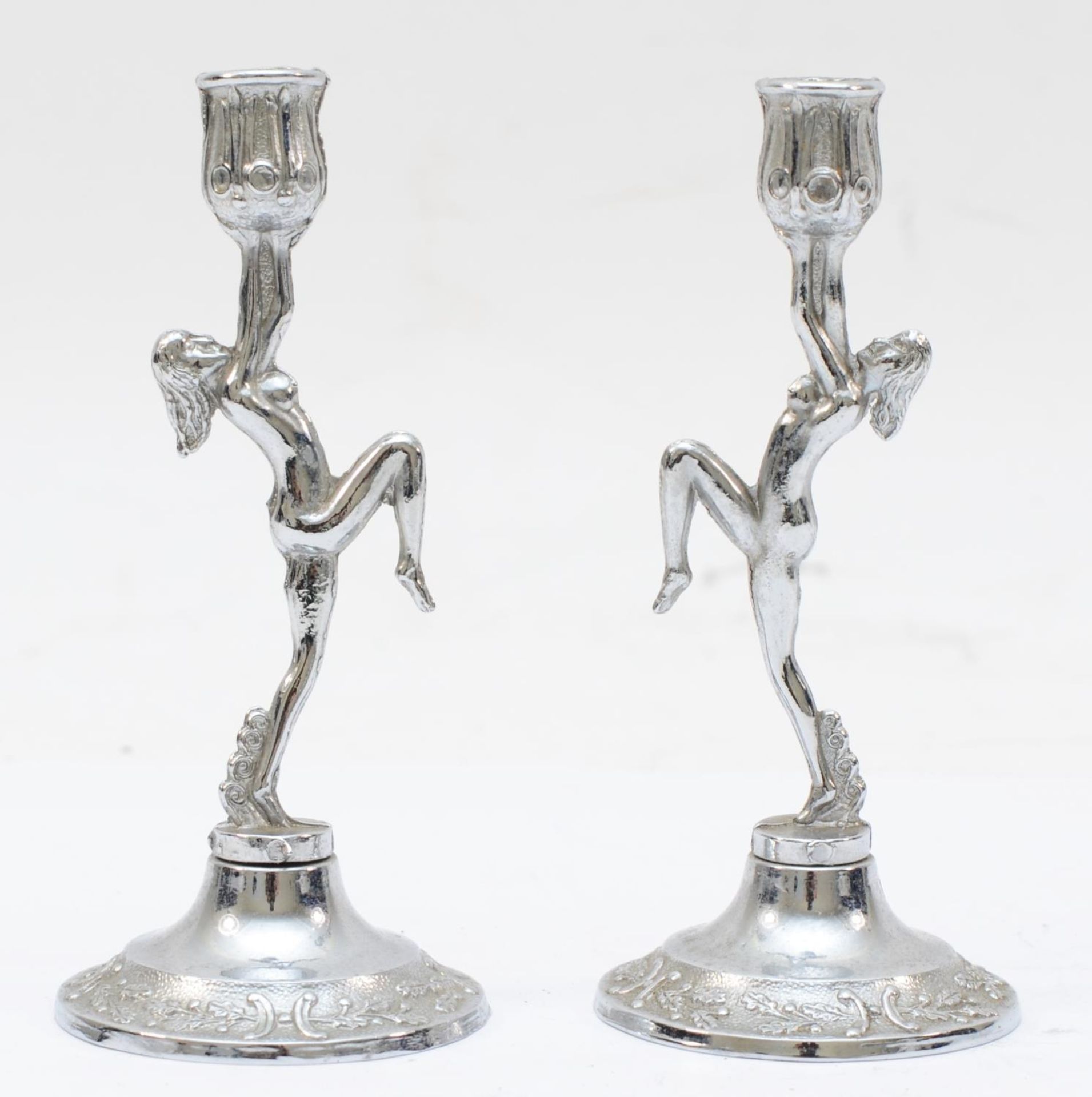 A pair of silver plated candle sticks in the Art Deco style, 11.5 x 5cm.