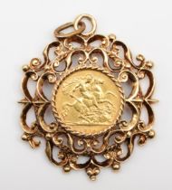 A George V 1914 half sovereign loose mounted in a 9ct gold pendent with scrolling decoration, 14gm